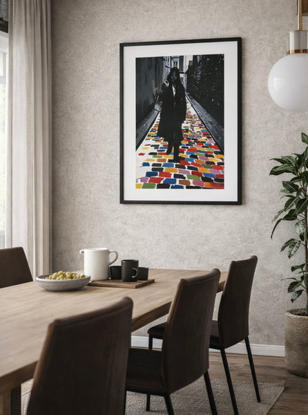 Dining room with a framed artwork on the wall above a table.
